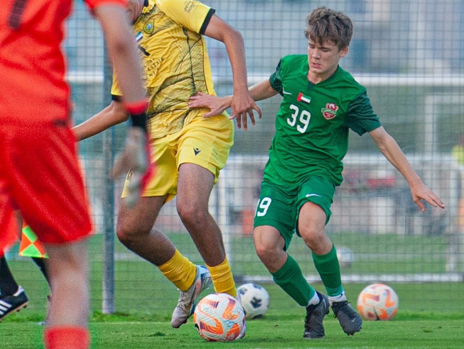 Max (green shirt, number 39) dribbling the ball for Shabab Al Ahli