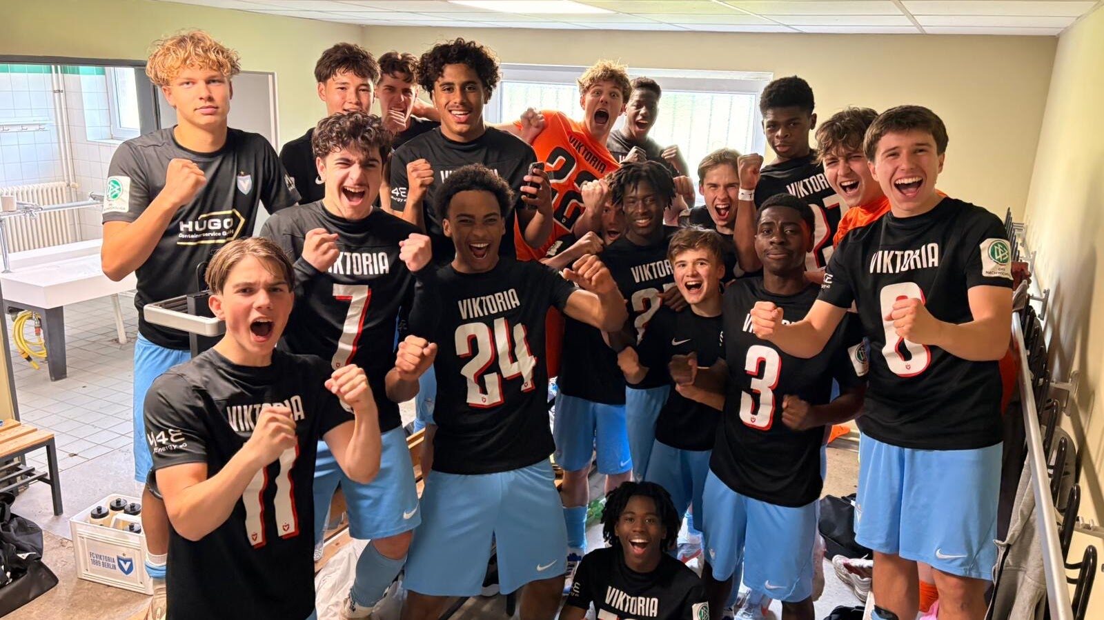 Viktoria U17 players celebrating in the dressing room